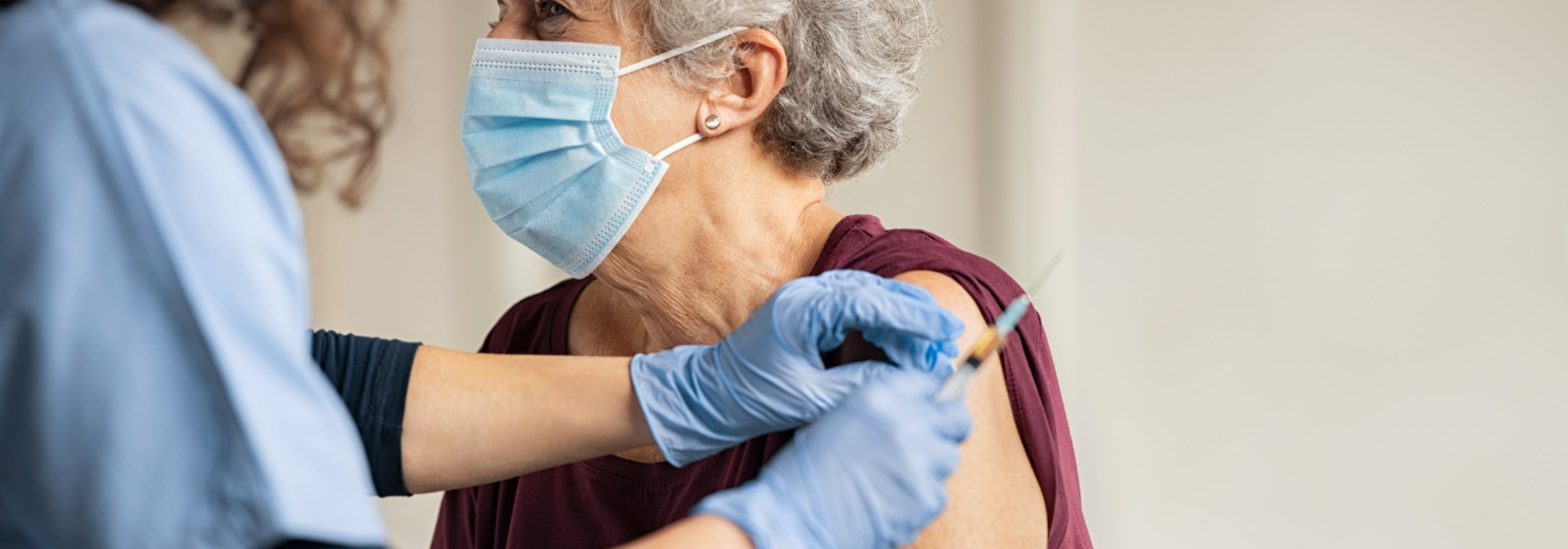 Healthcare worker delivering care to elderly patient