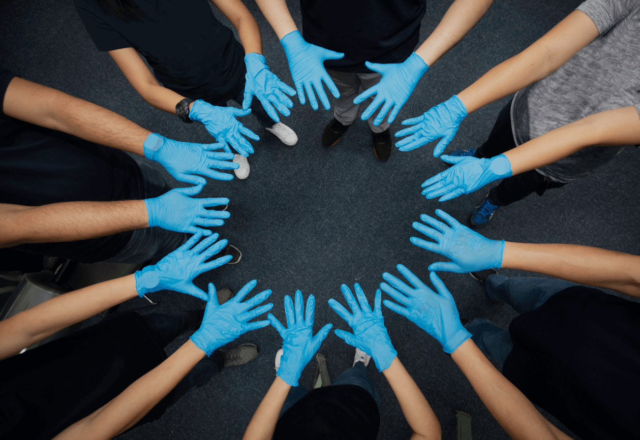 A team of NHS clinicians put their hands together in collaboration