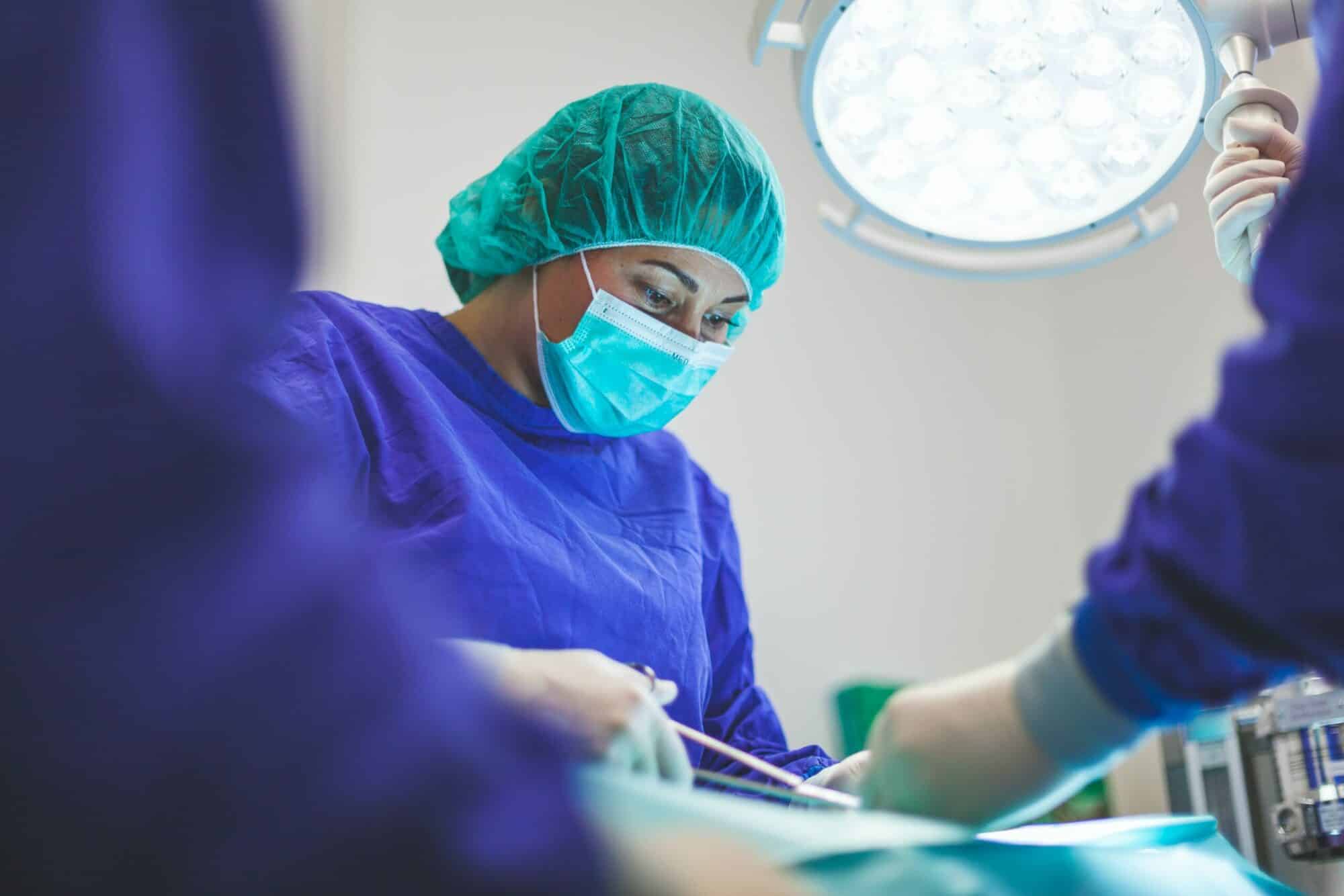 NHS surgeon operates on a patient